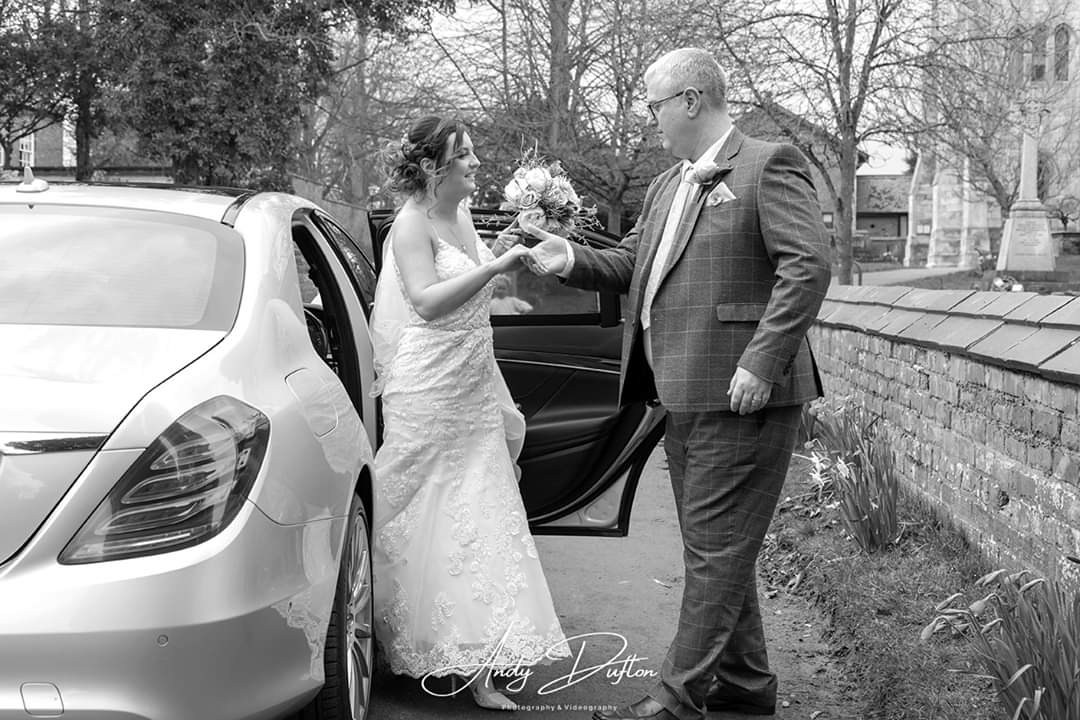 Bride to be and father stood next to our Mercedes wedding car